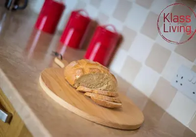 a loaf of bread on a cutting board on a counter at Kenmar House by Klass Living Hamilton in Hamilton