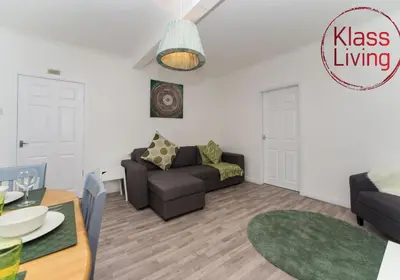 a living room with a couch and a table at Kenmar House by Klass Living Hamilton in Hamilton