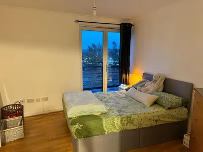 a bedroom with a bed with a teddy bear on it at Skyline Serenity Cosy Home in Glasgow