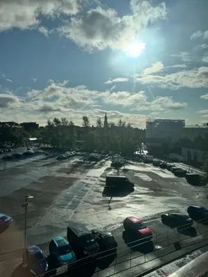 a parking lot with cars parked in a parking lot at Skyline Serenity Cosy Home in Glasgow
