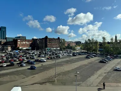 a parking lot full of cars in a city at Skyline Serenity Cosy Home in Glasgow