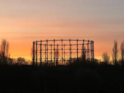 a silhouette of a structure with a sunset in the background at Luxury New York Style Loft Apartment Homestay in Edinburgh