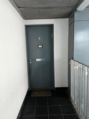 a blue door in a hallway with a tile floor at Luxury New York Style Loft Apartment Homestay in Edinburgh