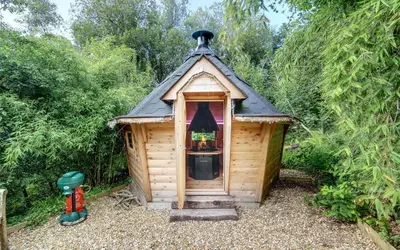 a small wooden cabin with a black roof at Scone Cottage - Luxury retreat, outstanding views in Craobh Haven