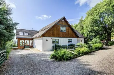 a house with a wooden roof and a driveway at Scone Cottage - Luxury retreat, outstanding views in Craobh Haven