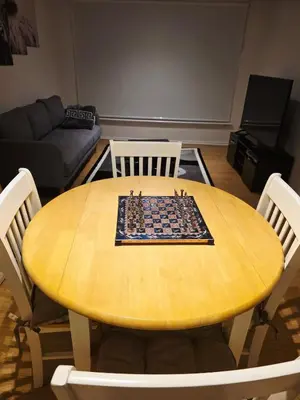 a wooden table with a chessboard on it in a living room at Cozy 2Bed Flat in Glasgow City Center in Glasgow