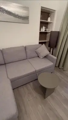 a living room with a couch and a table at Calm of Cumbrae in Millport