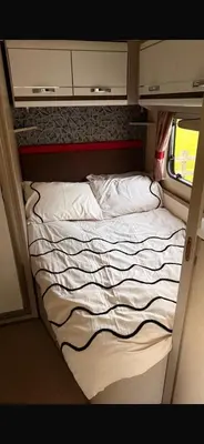 a bed in a small room in a train at 4 berth caravan in Doune
