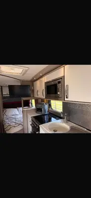 a small kitchen with a stove and a sink at 4 berth caravan in Doune