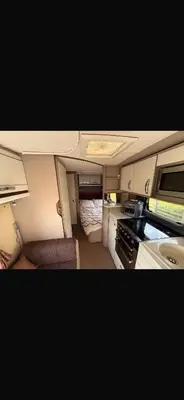 a small caravan with a kitchen and a bedroom at 4 berth caravan in Doune