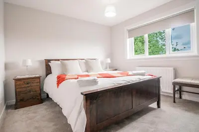 a bedroom with a large bed and a window at Stylish Stirling home with stunning views in Stirling