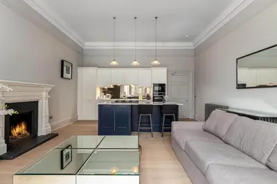 a living room with a couch and a fireplace at Victorian Apartment - city centre - free car space in Edinburgh
