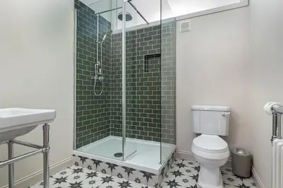 a bathroom with a shower with a toilet and a sink at Victorian Apartment - city centre - free car space in Edinburgh