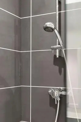 a shower with a shower head in a bathroom at The Clydesider in Glasgow