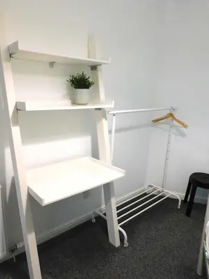 a white shelving unit with a potted plant on it at Bright 3 Bed Apt overlooking the Clyde SEC & Hydro in Glasgow