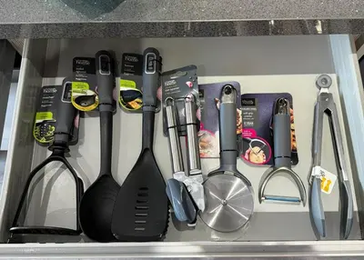 a drawer filled with cooking utensils in a kitchen at Bethany Woodland Lodge in Winchburgh