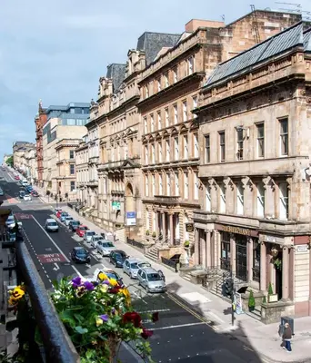a view of a city street with cars parked on the road at West George Street Apartment Glasgow in Glasgow