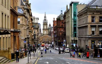 a busy city street with people crossing the street at West George Street Apartment Glasgow in Glasgow