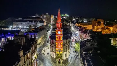 a tall clock tower in a city at night at Hidden Gem in Stirling