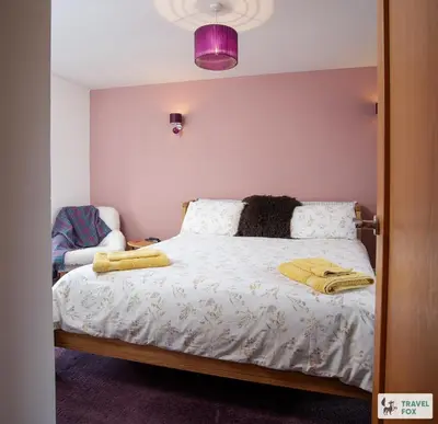 a bedroom with a bed with two towels on it at Charlotte Street Stay in Port Ellen