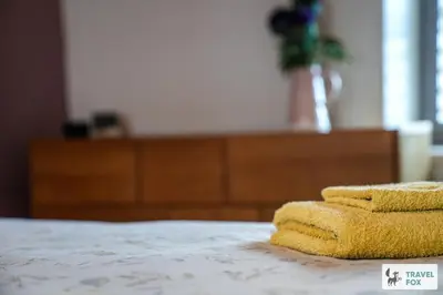 a pile of towels sitting on top of a bed at Charlotte Street Stay in Port Ellen