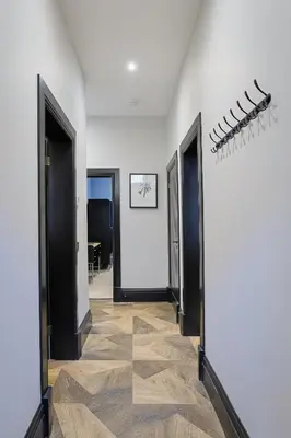 a hallway with three doors and a hallway with a floor at No 4 Burnbank in Oban