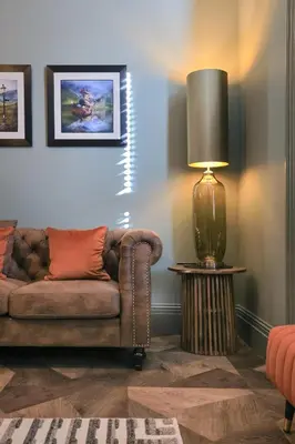 a living room with a couch and a lamp at No 4 Burnbank in Oban