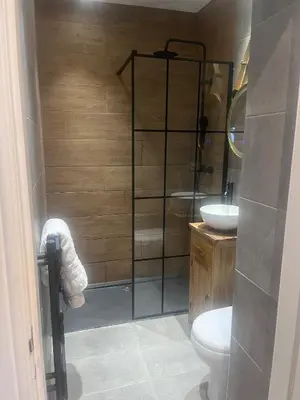 a bathroom with a shower with a toilet and a sink at Scottish White House in Edinburgh