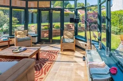 a living room with furniture and large windows at Scottish White House in Edinburgh