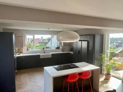 a kitchen with two red bar stools and a sink at Scottish White House in Edinburgh