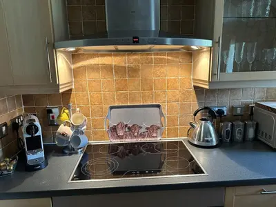 a kitchen counter with a sink and a stove at 6 Lomond Castle - The Inchcruin Suite in Luss