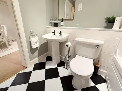 a bathroom with a white toilet and a sink at Blantyre Cosy Hideaway in Edinburgh
