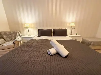 a bedroom with a large bed with two towels on it at Blantyre Cosy Hideaway in Edinburgh