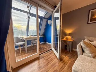 a living room with a large window and a couch at Riverside 1bd - Balcony & Parking Hydro SECC in Glasgow