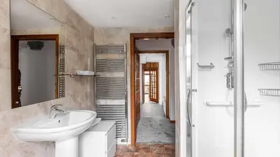 a bathroom with a sink and a shower at Craigend Cottage in Rothesay