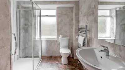 a bathroom with a toilet and a sink and a shower at Craigend Cottage in Rothesay