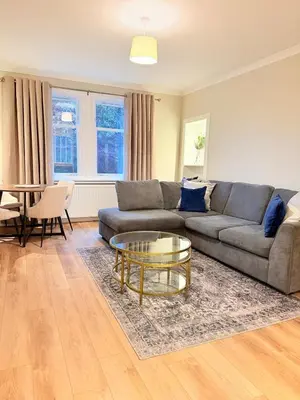 a living room with a couch and a table at Bright and spacious 2 bedroom flat in Auchterarder
