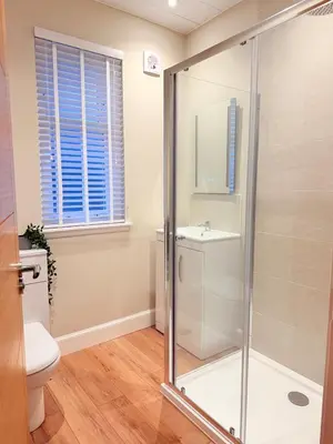 a bathroom with a shower and a toilet at Bright and spacious 2 bedroom flat in Auchterarder