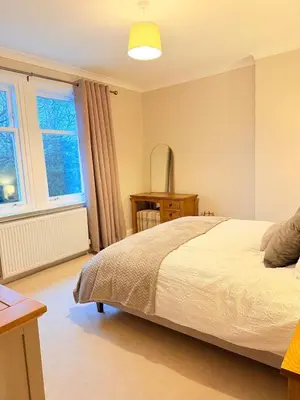 a bedroom with a bed and a window at Bright and spacious 2 bedroom flat in Auchterarder