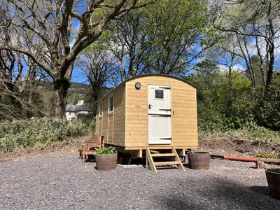 a tiny house sitting on a stand in a yard at Melfort House in Kilmelford