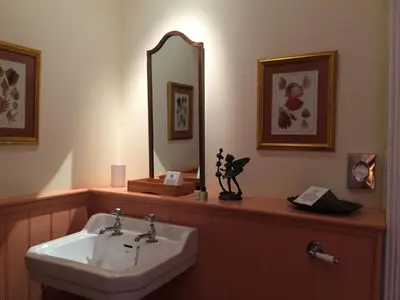 a bathroom with a sink and a mirror at Melfort House in Kilmelford