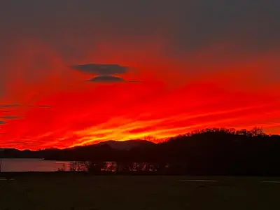 a sunset with a red sky and clouds at Melfort House in Kilmelford
