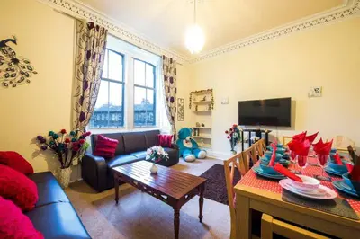 a living room with a couch and a table at Edinburgh Central Morrison Roomz in Edinburgh