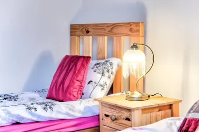 a bedroom with a bed and a lamp on a table at Edinburgh Central Morrison Roomz in Edinburgh