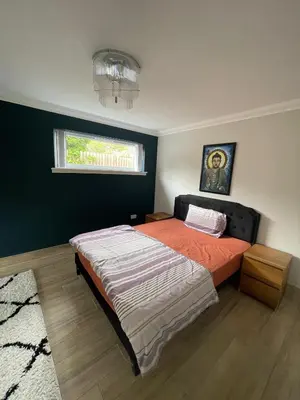 a bedroom with a bed and a window at ShekNup Home in Edinburgh