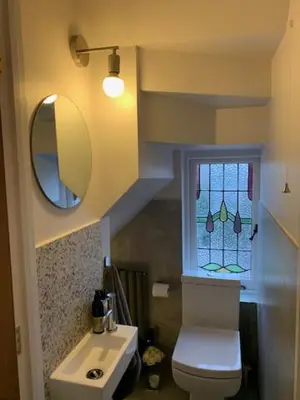 a bathroom with a sink and a toilet and a window at Crouch End in Moffat