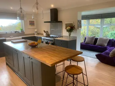 a kitchen with a island with a wooden counter top at Spacious, bright home in Central Scotland sleeps 6 in Balfron