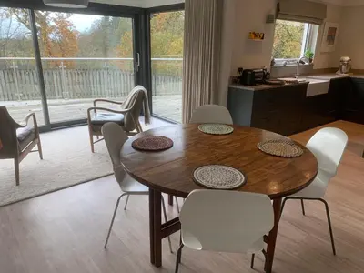 a kitchen and dining room with a table and chairs at Spacious, bright home in Central Scotland sleeps 6 in Balfron