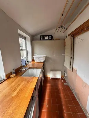 a kitchen with a sink and a counter top at Curlew Cottage - Peaceful Setting Stunning Views in Bruichladdich