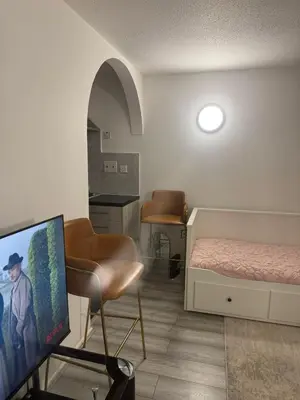 a room with a bedroom with a bed and a tv at House of Card in Moffat